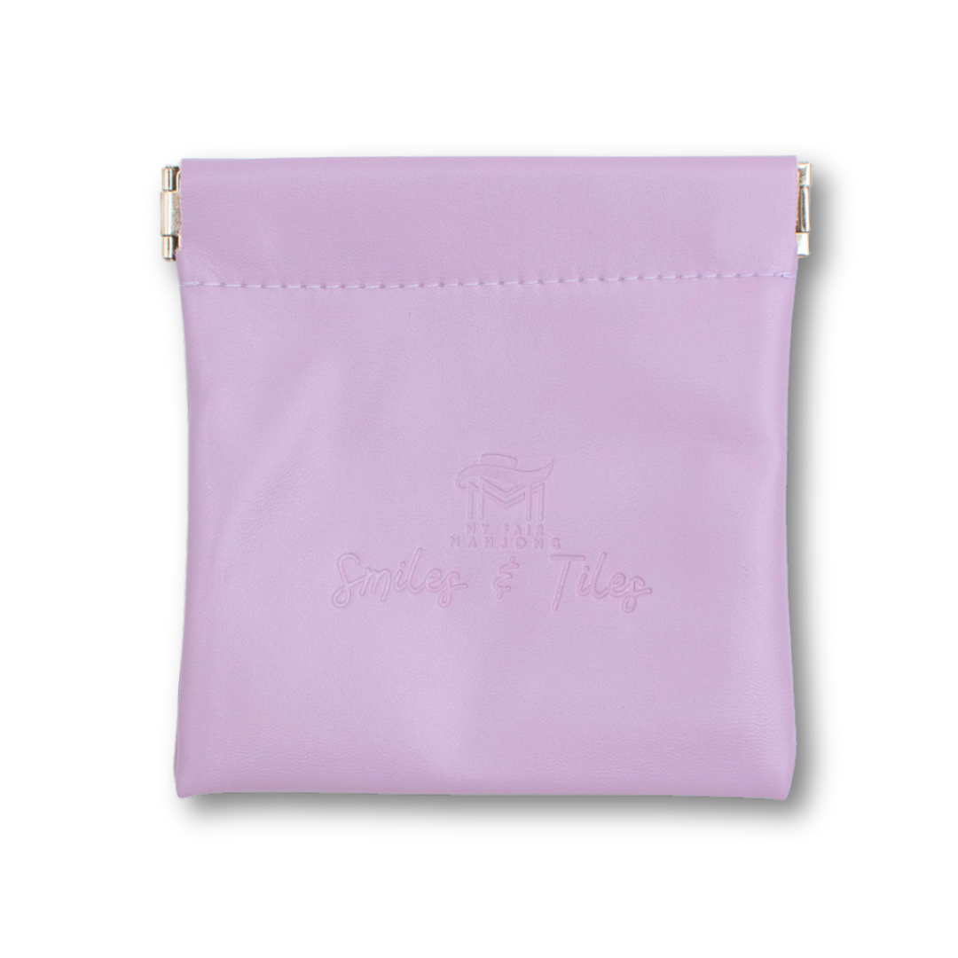 Purple Mahjong coin and dice purse holding tiles and game accessories.