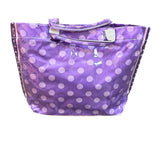 Purple PVC tote bag with dark purple sides, light purple polka dots, and sturdy handles.