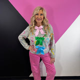 Grey cardigan with multicolor sequin candy canes and oversized pink, green, and blue bows.