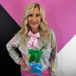 Grey cardigan with multicolor sequin candy canes and oversized pink, green, and blue bows.