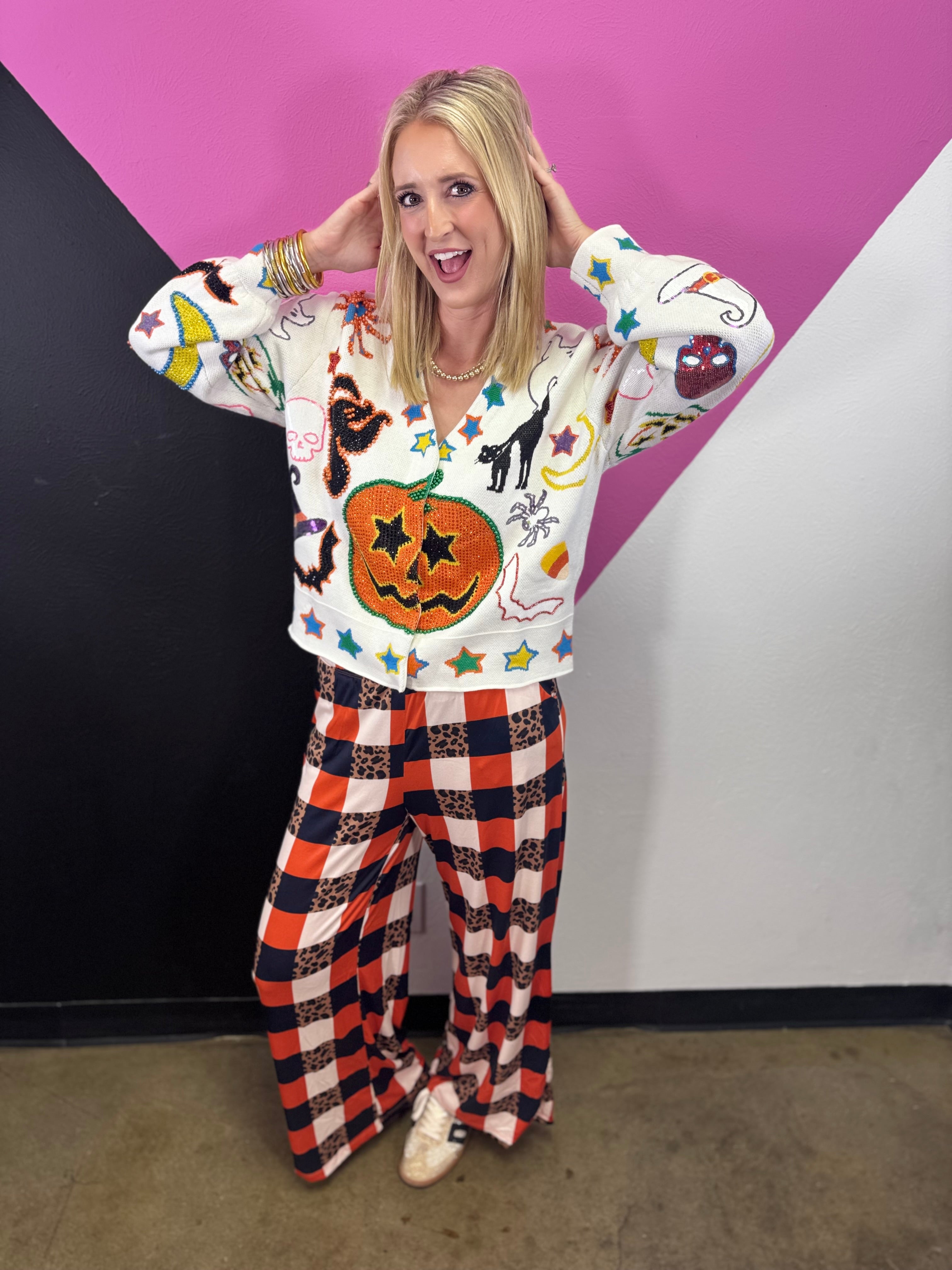 Ivory Halloween cardigan with orange jack-o'-lantern, ghosts, black cats, bats, and spooky icons.