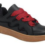 Black sneakers with chunky tan sole and oversized red woven laces.