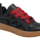 Black sneakers with chunky tan sole and oversized red woven laces.