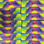 Rainbow butter-shaped squishy stress toy with colorful sensory design.