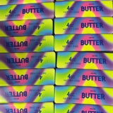 Rainbow butter-shaped squishy stress toy with colorful sensory design.