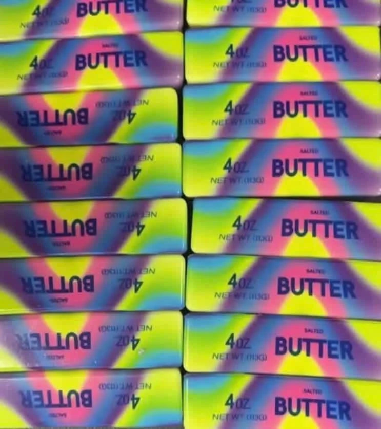 Rainbow butter-shaped squishy stress toy with colorful sensory design.