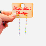Rainbow drop earrings with gold stud and colorful beaded strands.