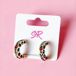 Small gold hoops with rainbow rhinestones, hypoallergenic and perfect for everyday wear.