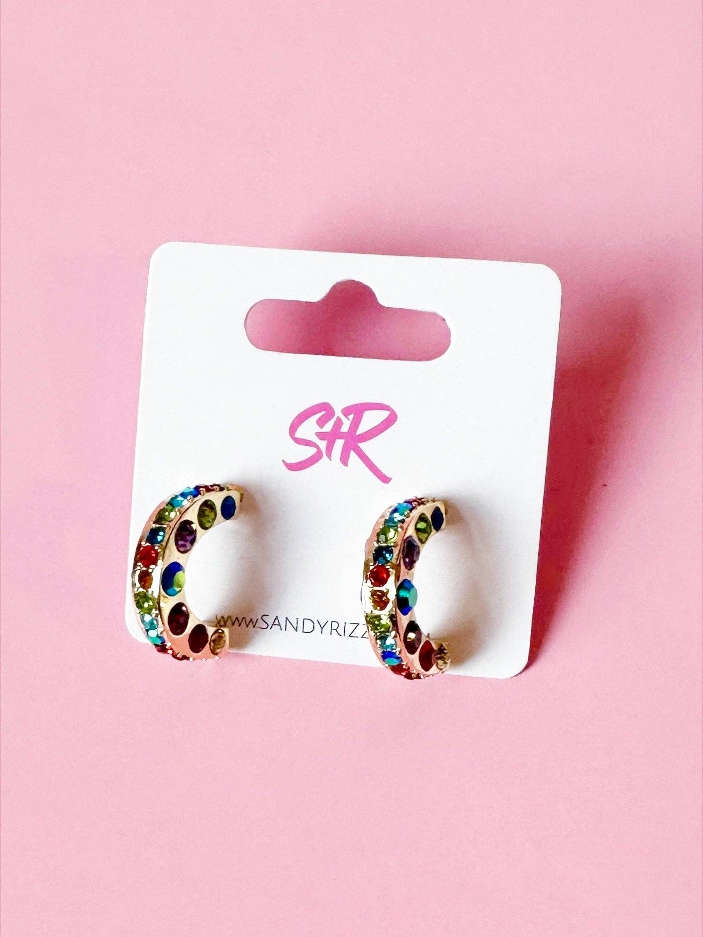 Small gold hoops with rainbow rhinestones, hypoallergenic and perfect for everyday wear.