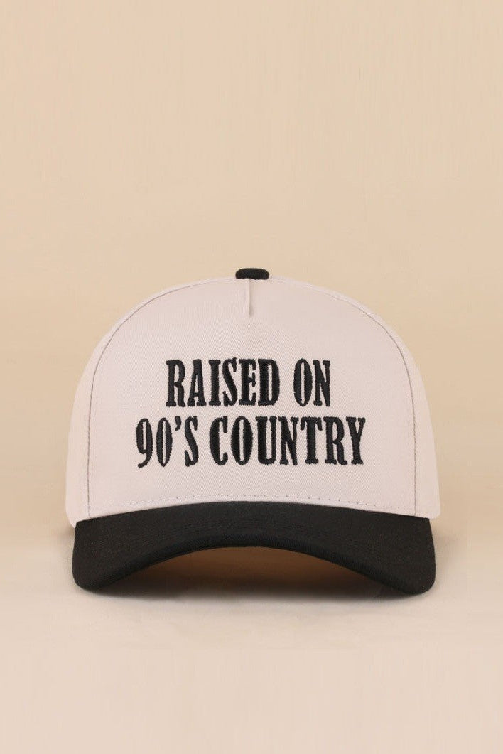Two-tone snapback hat with Raised On 90's Country embroidered detail.