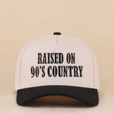 Two-tone snapback hat with Raised On 90's Country embroidered detail.