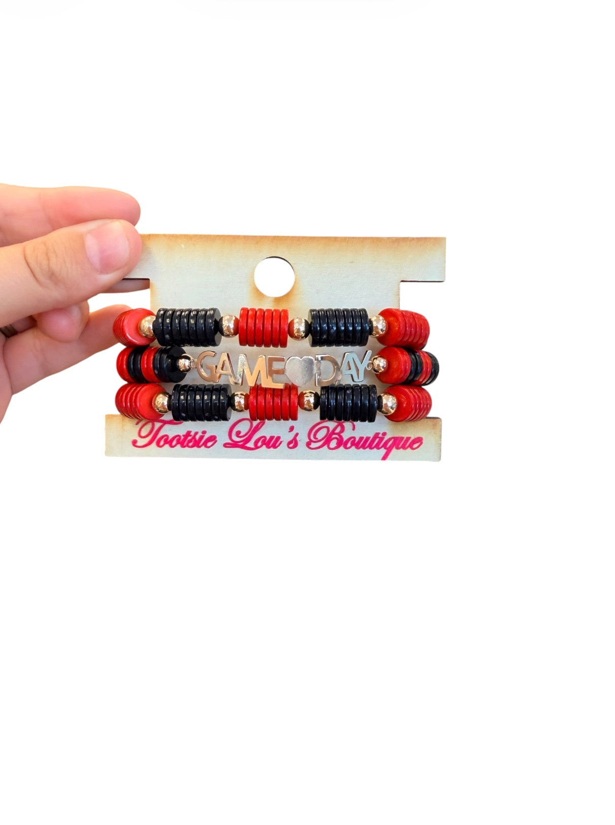 Black and red Game Day bracelet stack with gold charm accents.