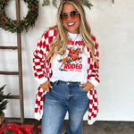 Oversized red and white checkered cardigan with open front, long length, and front pockets.