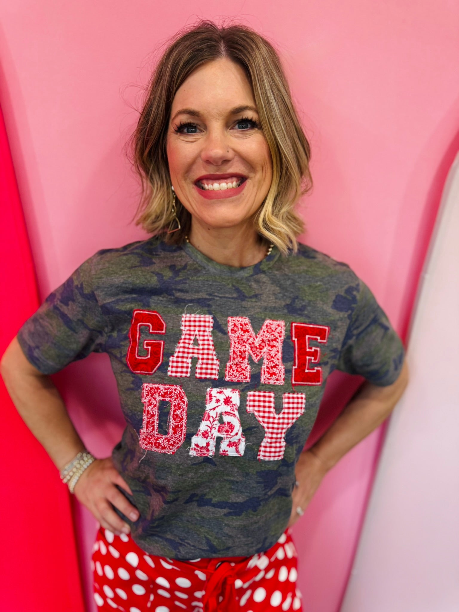 Red Game Day tee with patchwork appliqué lettering and mixed print details.