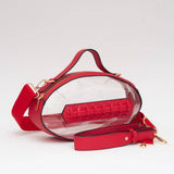 Red football-shaped vegan leather crossbody bag with gold hardware, top handle, and adjustable strap
