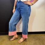 Medium wash straight-leg jeans with bold red and white gingham check cuffs.