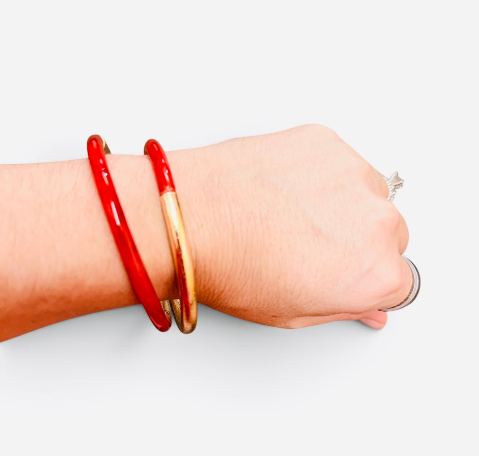 Red enamel cuff bracelet with textured brushed gold-tone finish.