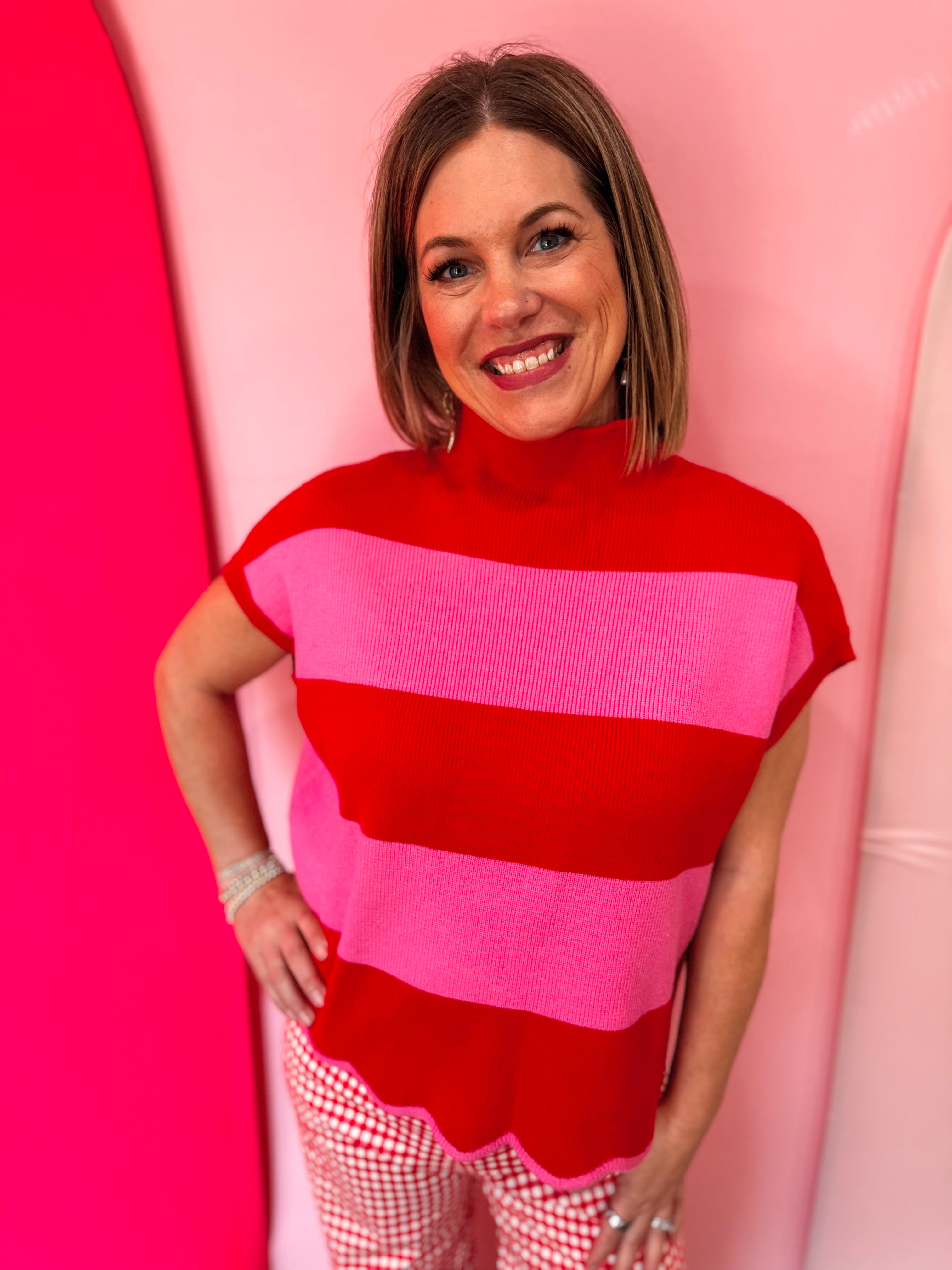Red and pink striped mock neck sweater with scalloped hem.