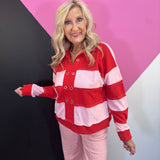 Red and pink striped pullover with grommet neckline, exposed seams, and long sleeves