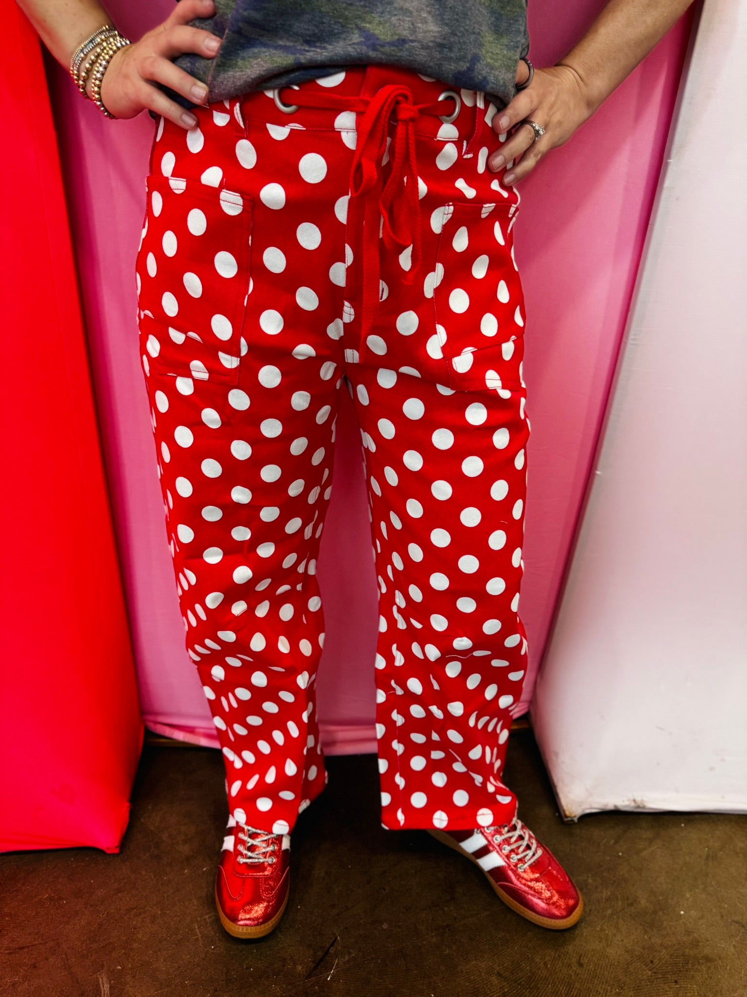 Red and white polka dot cropped barrel pants with drawstring waist and pockets.