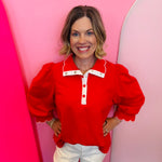 Red puff sleeve top with scalloped trim and contrast neckline