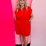 Ruby red textured jacquard mini dress with quarter zipper neckline, side pockets, and high-low hem.