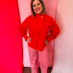 Red cotton blouse with ruffle mock neck and balloon sleeves.