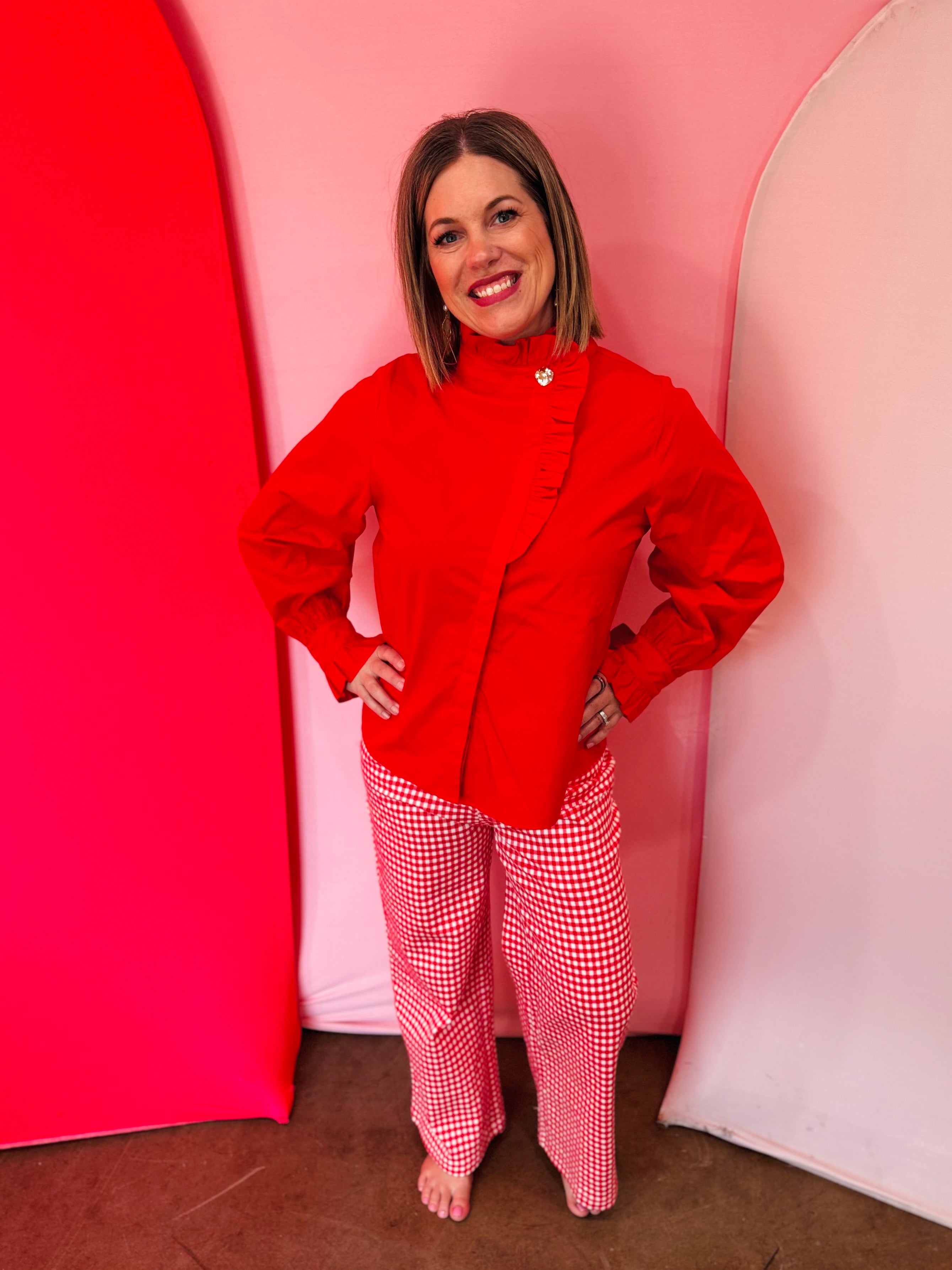 Red cotton blouse with ruffle mock neck and balloon sleeves.