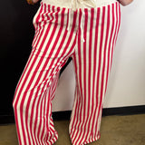 Red and white vertical striped wide leg pants with drawstring waist and pockets.