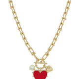 Gold chain necklace with red studded heart charm featuring adjustable 16 to 18 inch length.