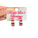 Red and white striped enamel hoop earrings with polished gold-tone finish.
