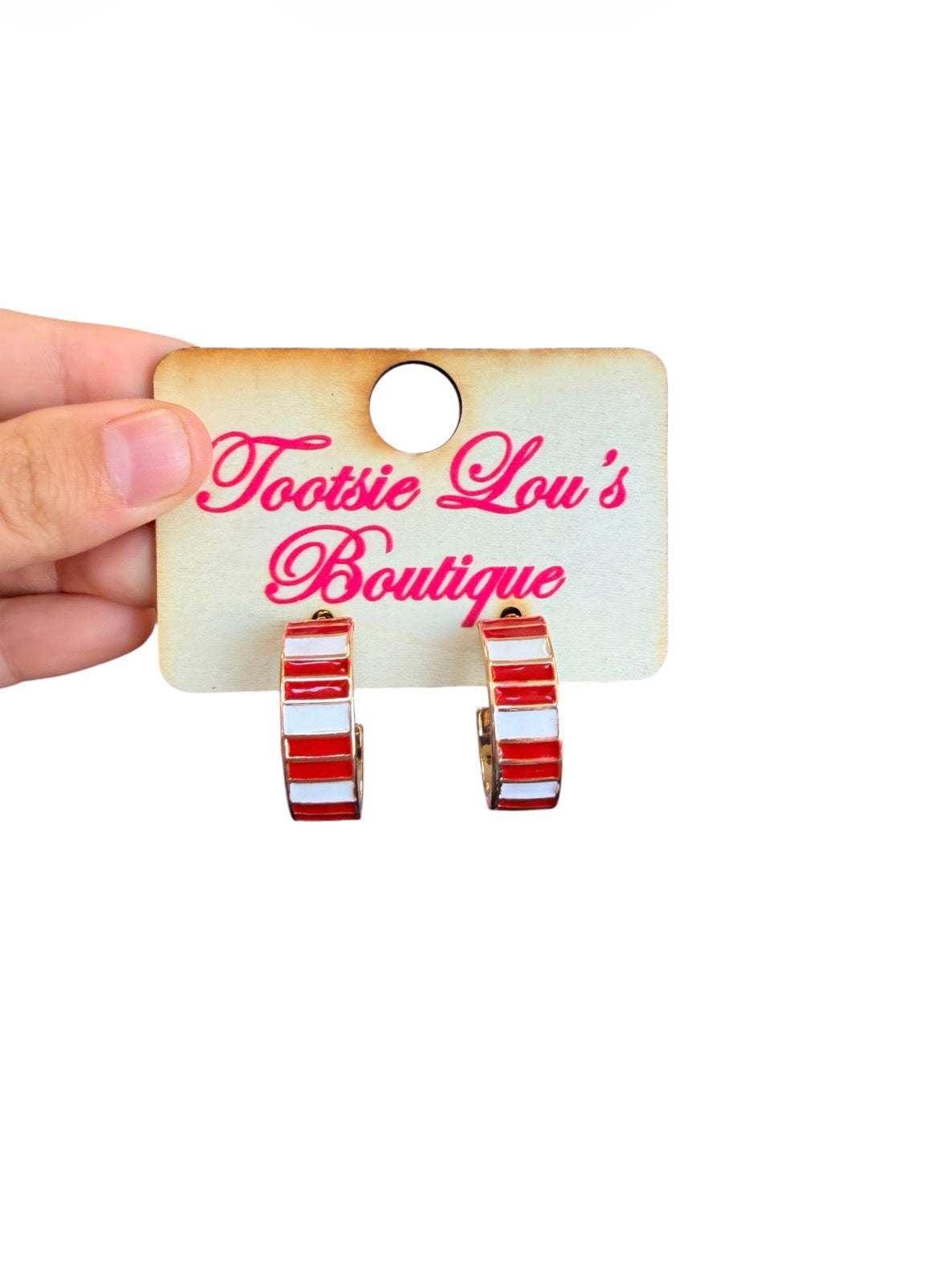 Red and white striped enamel hoop earrings with polished gold-tone finish.
