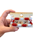 Red and white Game Day bracelet stack with gold charm accents.
