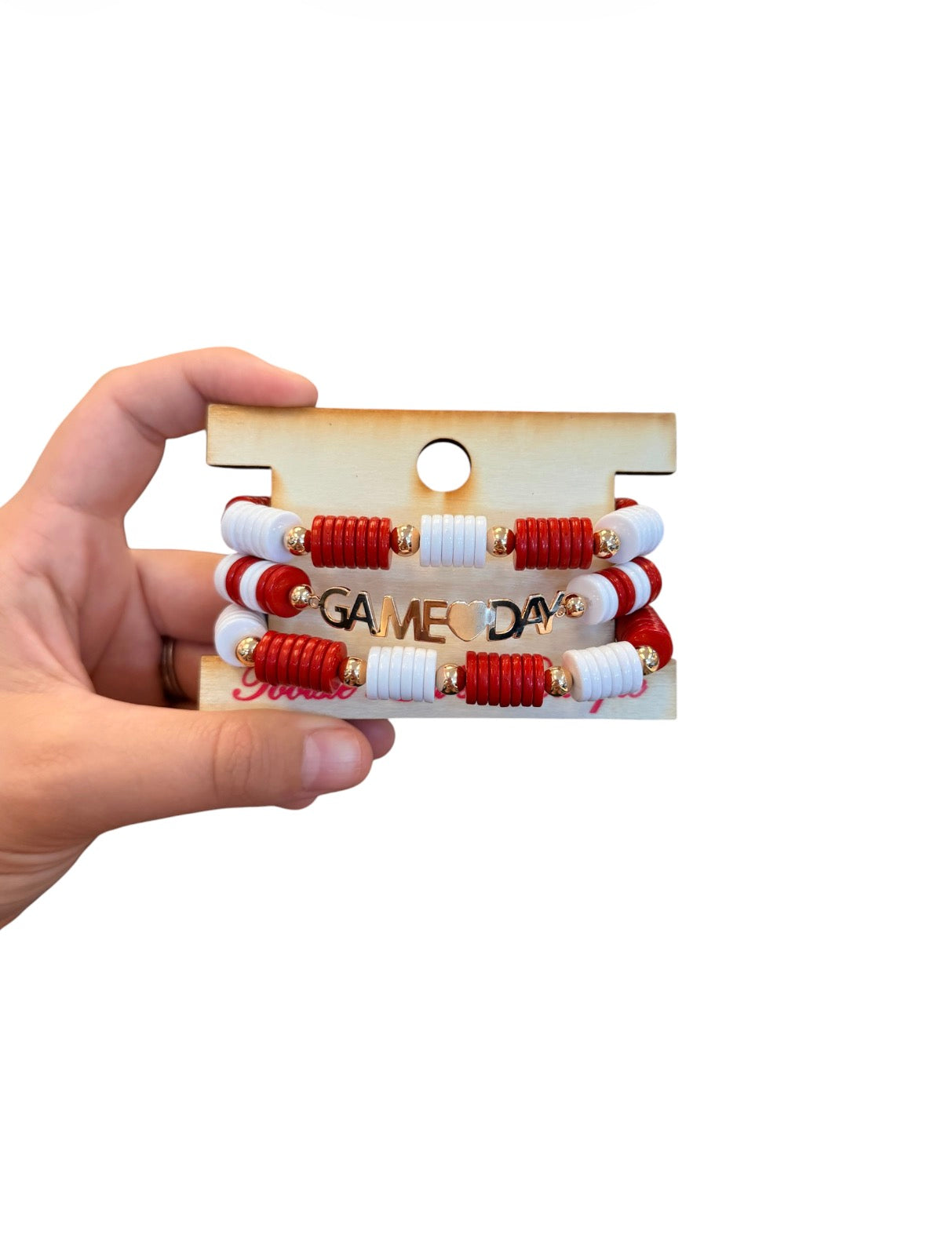 Red and white Game Day bracelet stack with gold charm accents.
