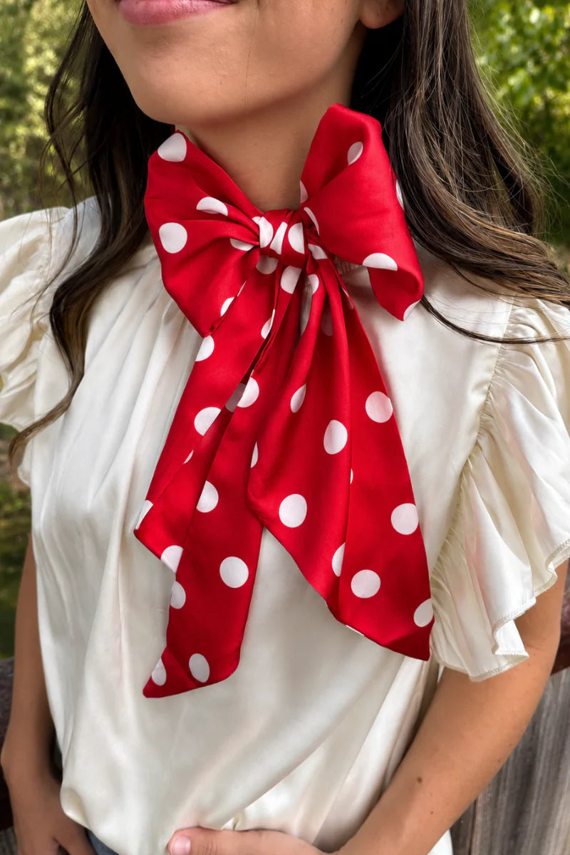 Red and white silky polka dot scarf with versatile styling options.