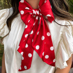 Red and white silky polka dot scarf with versatile styling options.