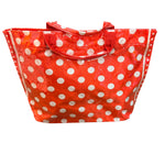 Red PVC tote bag with white polka dots, sturdy top handles, interior pockets, and Velcro closure.