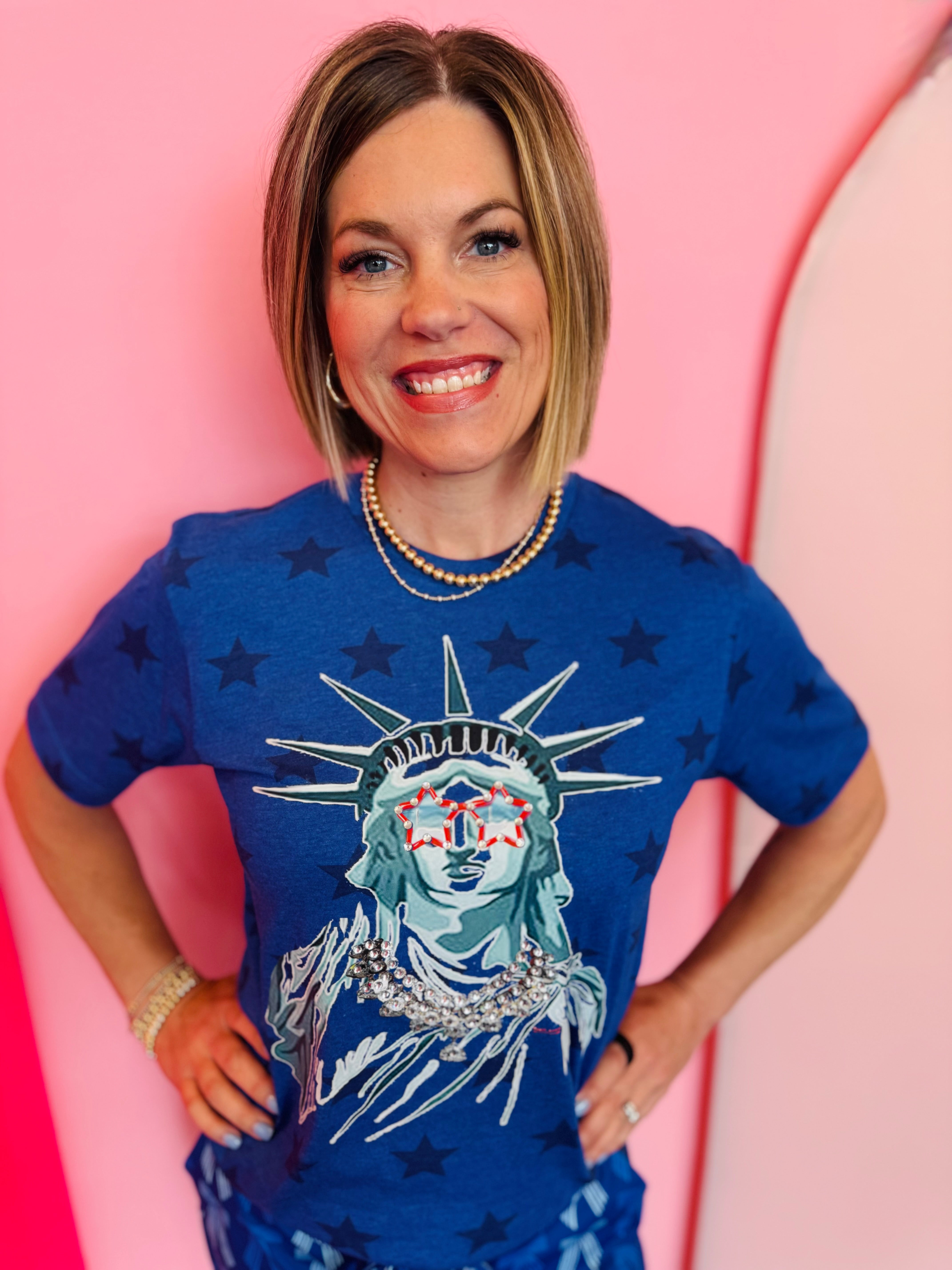 Blue Lady Liberty graphic tee with rhinestone star sunglasses and collared neckline