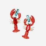 Red rhinestone lobster earrings with turquoise stud set in gold, bold coastal statement jewelry.