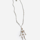Rhinestone skeleton necklace with dangling crystal-covered skeleton pendant.