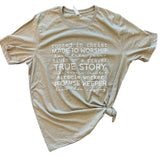 Taupe tee with white “Rooted In Christ” and faith-based phrases in clean minimalist lettering.