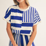 Royal blue and white striped colorblock top with mixed stripe panels and relaxed drop shoulder fit