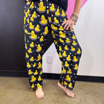 Black pants with bright yellow rubber ducks, white bubble accents, and elastic waistband.