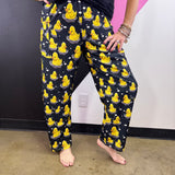 Black pants with bright yellow rubber ducks, white bubble accents, and elastic waistband.