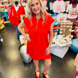 Ruby red textured jacquard mini dress with quarter zipper neckline, side pockets, and high-low hem.