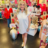 Sand beige textured jacquard mini dress with quarter zipper neckline, side pockets, and high-low hem.