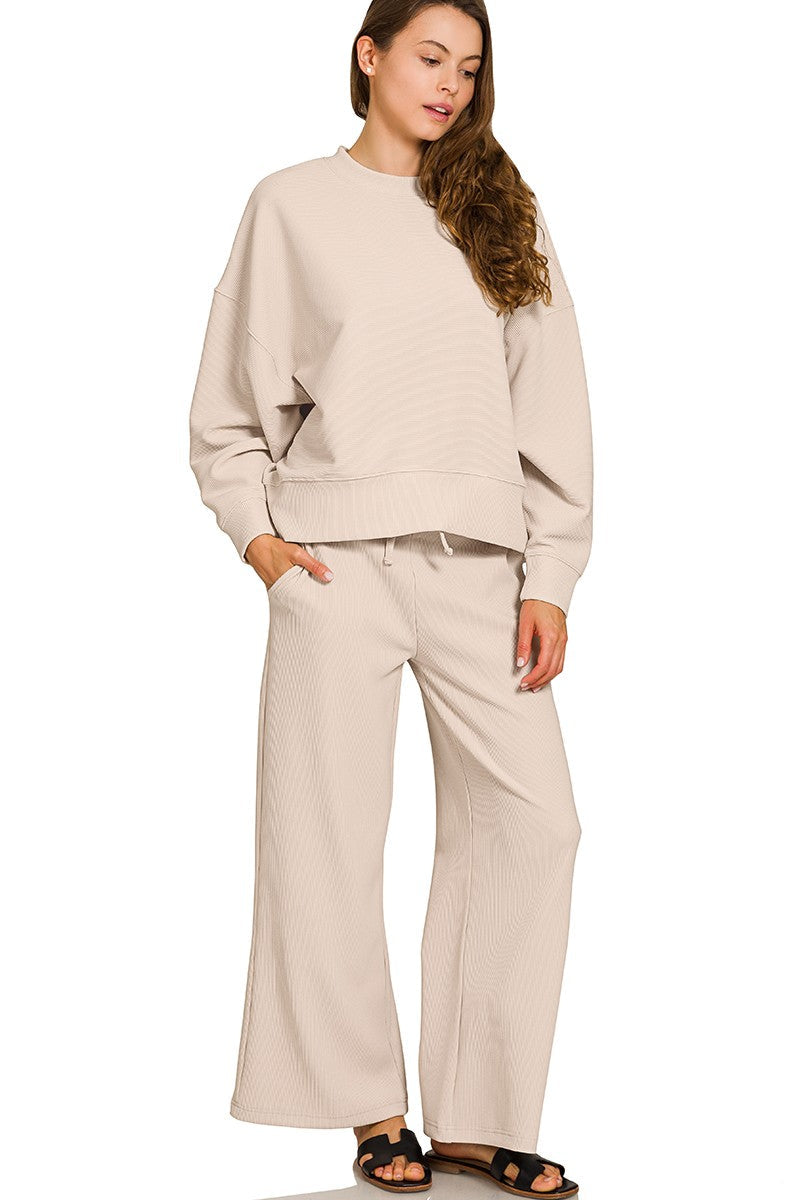 Sand beige ribbed knit pullover and pants set with round neck, elastic waist, and relaxed fit.