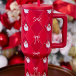 40oz tumbler with Santa design, bow accents, handle, and reusable straw.