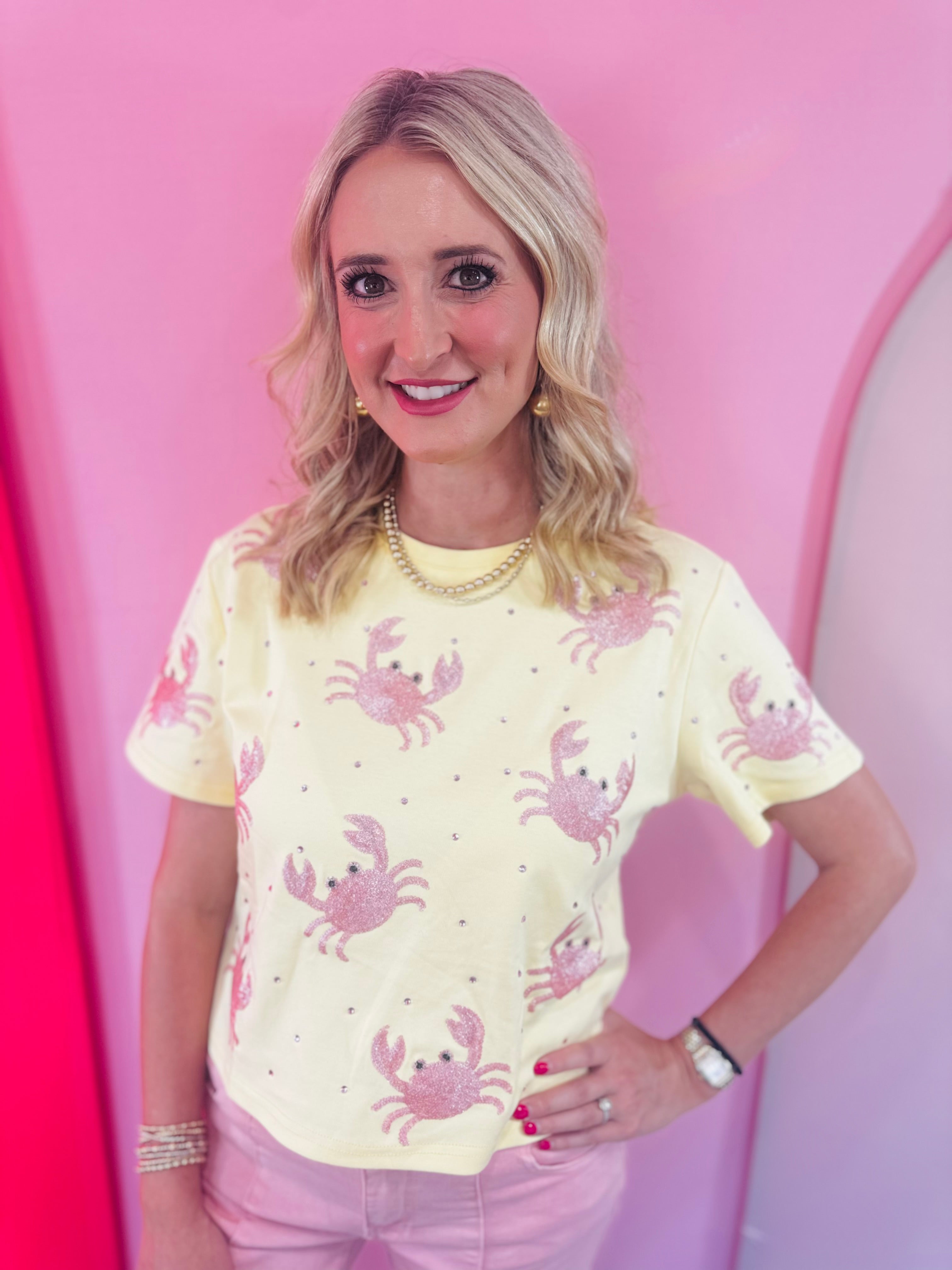 Butter yellow top with pink sequin crabs and pink rhinestone accents.
