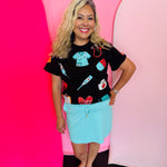 Black nurse top with colorful sequin healthcare icons and short sleeves.